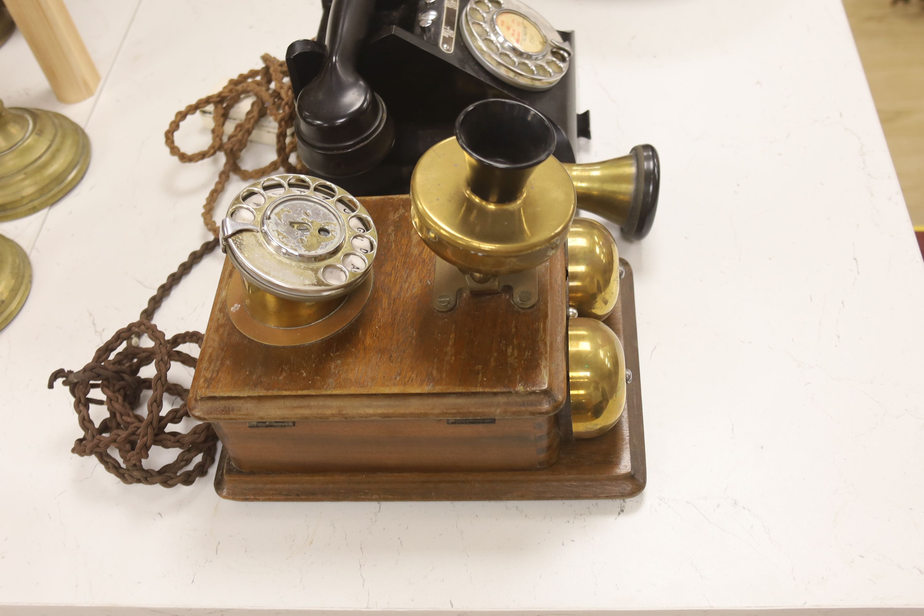 A 20th century black bakelite telephone, Slindon 232, the receiver marked 164-48, together with a further early timber cased telephone